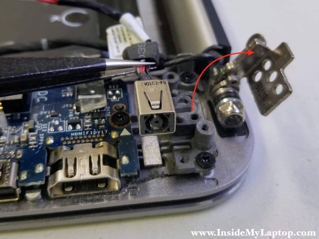 Open up display hinge and remove DC power jack