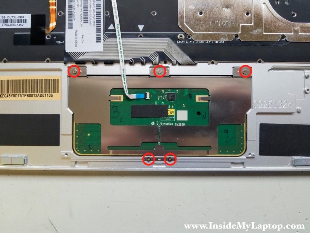 Remove five screws securing touchpad