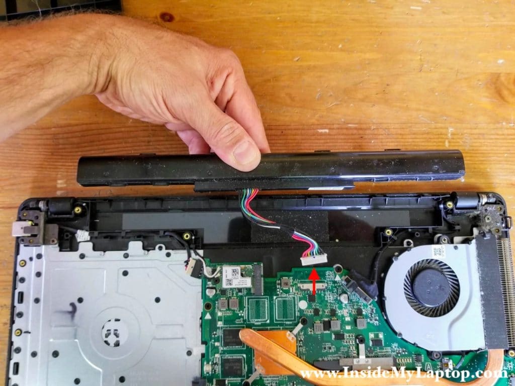 Lift up the battery and disconnect the cable from the motherboard.