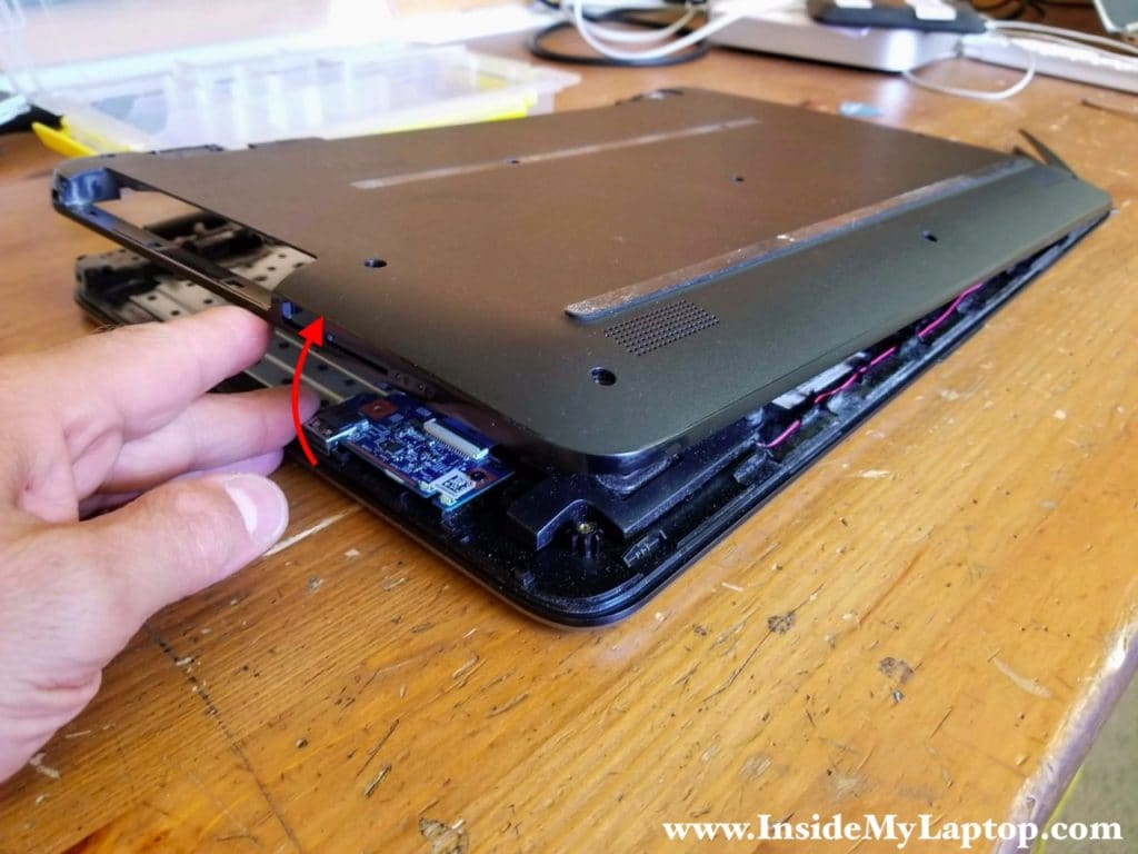 Turn the laptop upside down and continue separating the bottom cover.