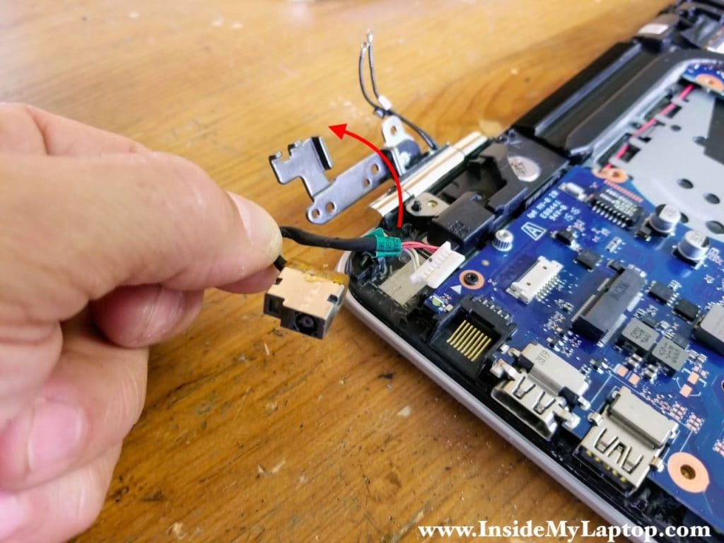 Open the right display hinge. Disconnect and remove the DC power jack harness.