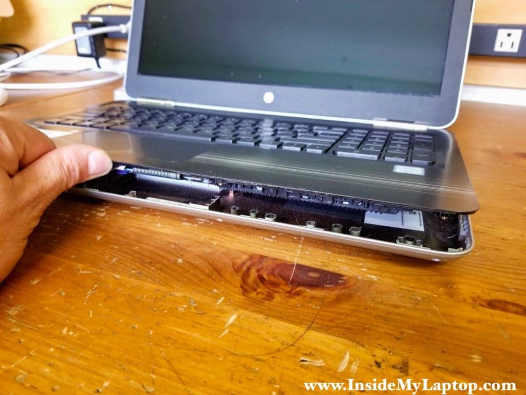 Continue separating the top case with your fingers while helping with the case opener.