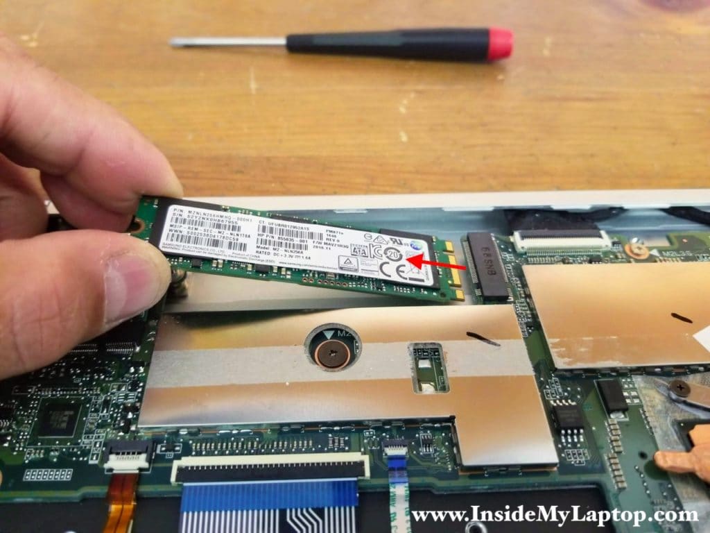 Remove one screw securing the solid state drive and pull it out.