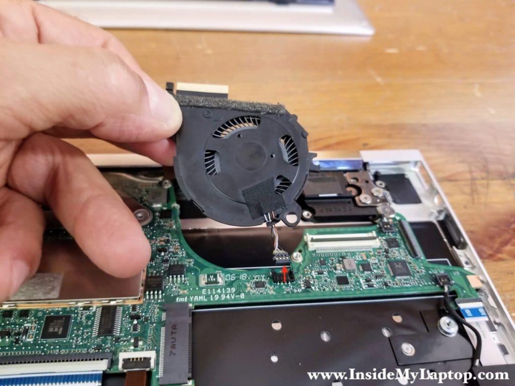 Lift up the left cooling fan and disconnect it from the motherboard.