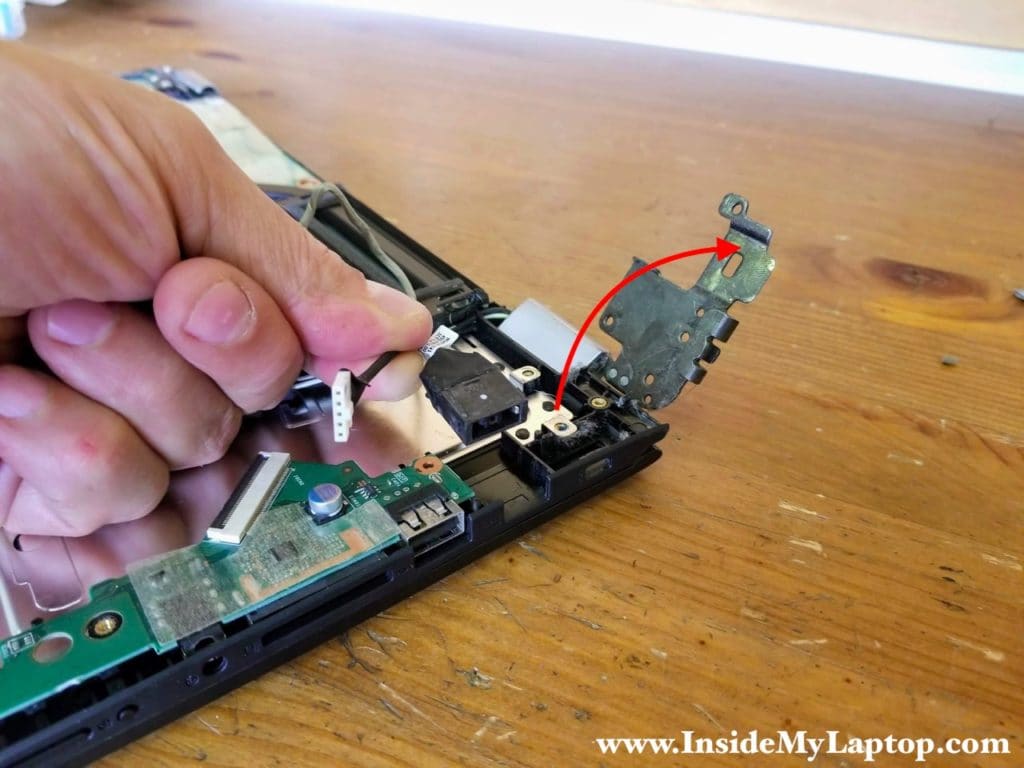 Open the left display hinge and remove DC power jack harness.