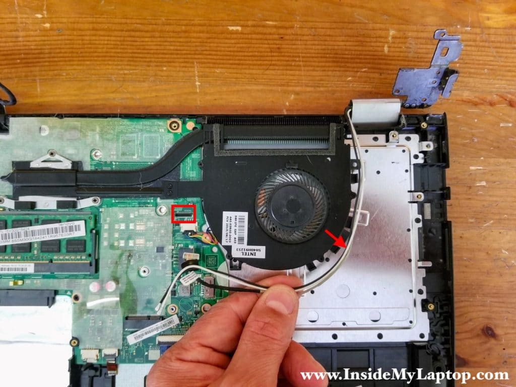 Unplug the webcam cable from the motherboard and unroute all cables from the fan.