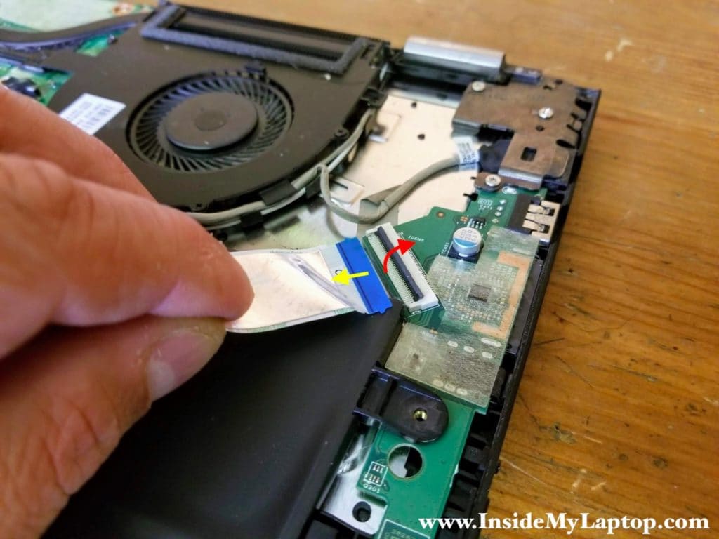 Unlock the connector by lifting up the locking tab (red arrow). After that you can pull the cable out (yellow arrow).