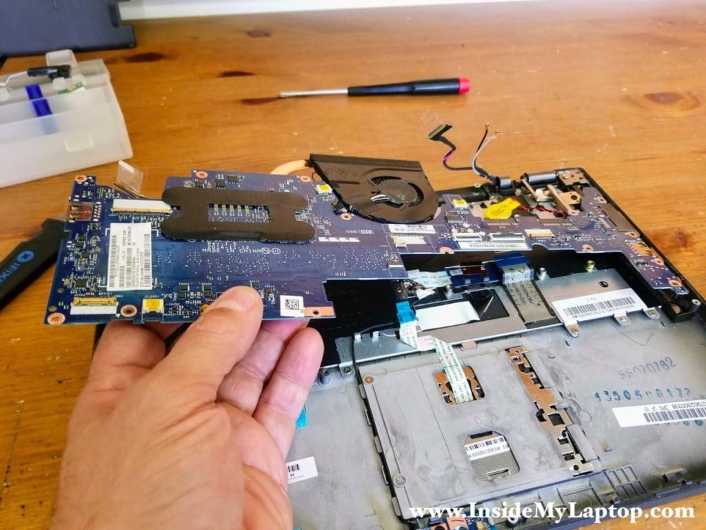 Carefully lift up the motherboard and remove it from the palmrest assembly.