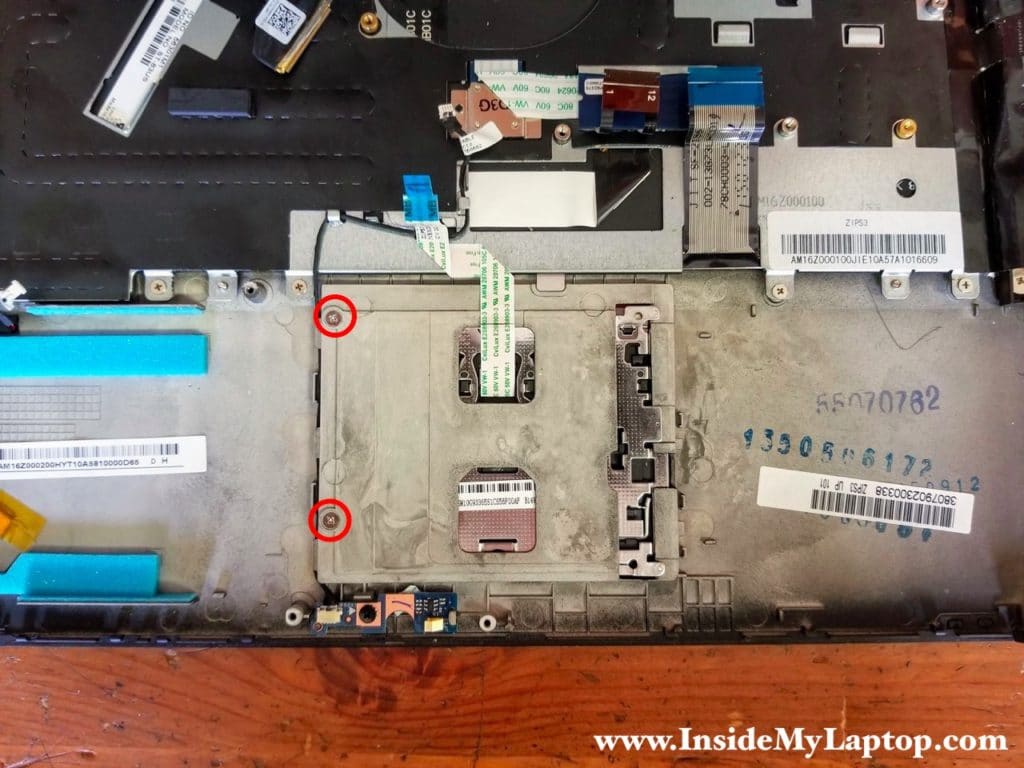 Remove two screws from touchpad and unglue the cable.