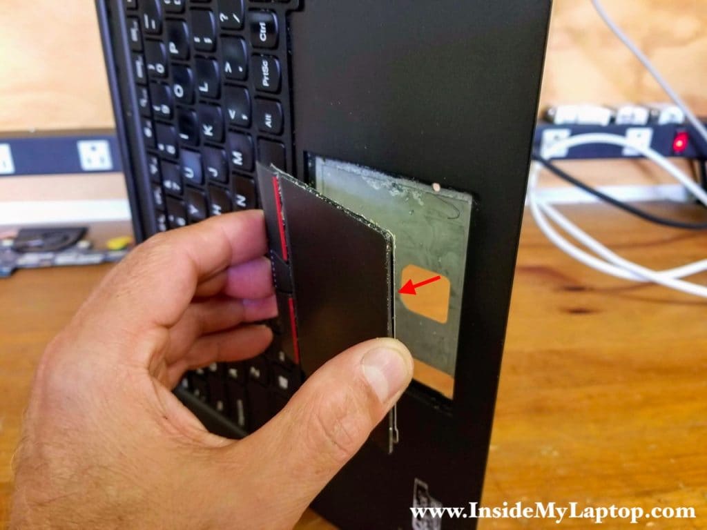 Place the laptop on its side and remove the touchpad.