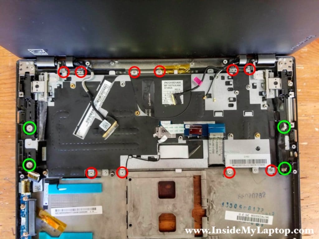 Remove fourteen screws (four large and ten small) securing the keyboard assembly to the frame.