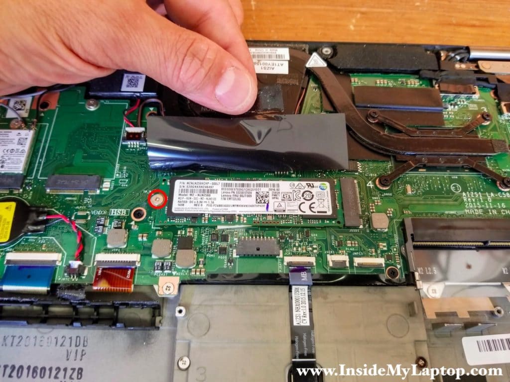 Remove one screw securing the solid state drive to the motherboard.