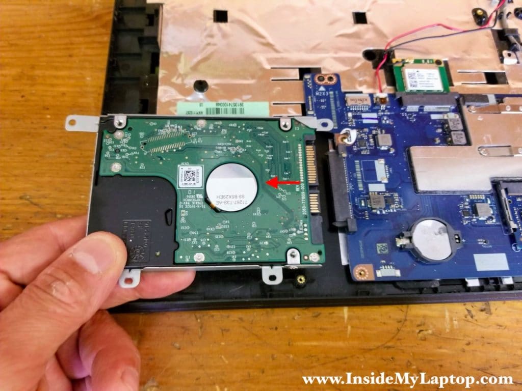 Slide the hard drive assembly to the left to disconnect it from the SATA port and remove it.