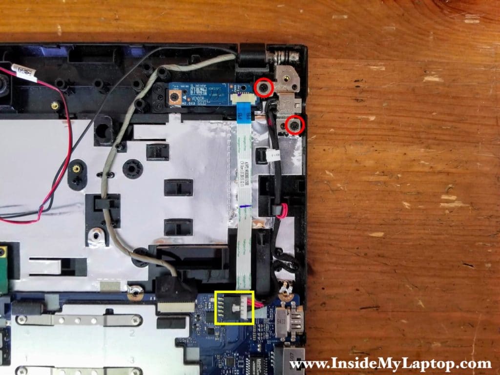 Remove two screws securing the left display hinge and unplug the DC jack cable from the motherboard.