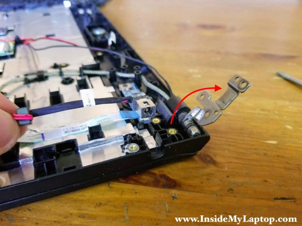 Open up the display hinge and remove the DC power jack harness.