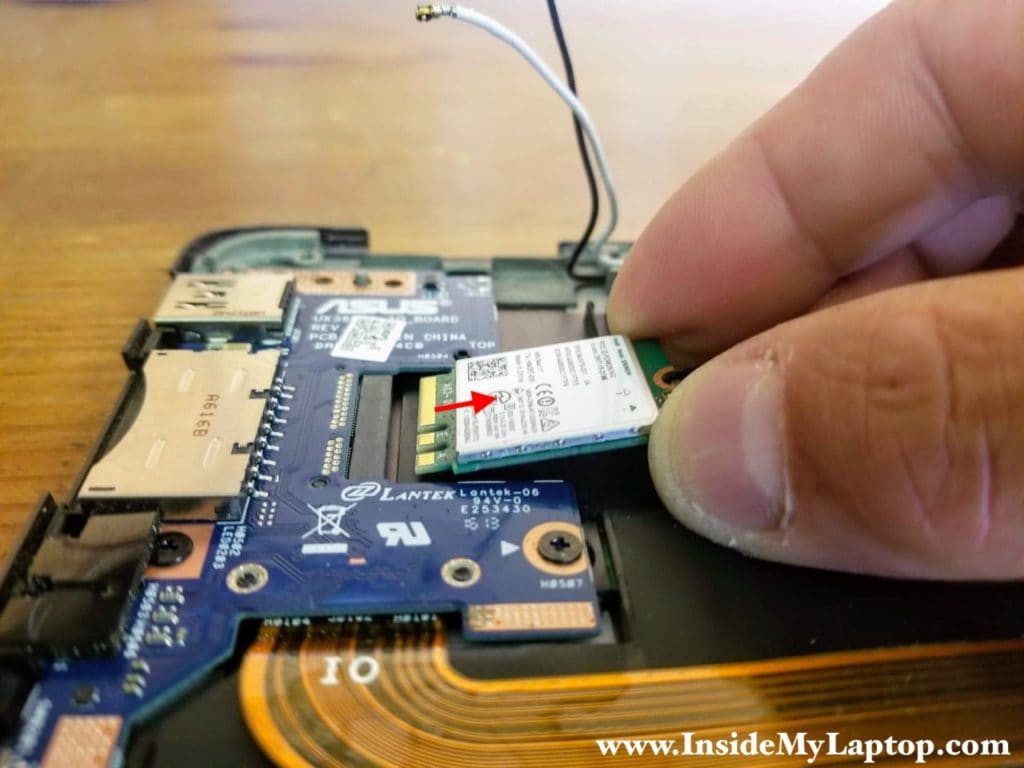 Pull the wireless card out to remove it.