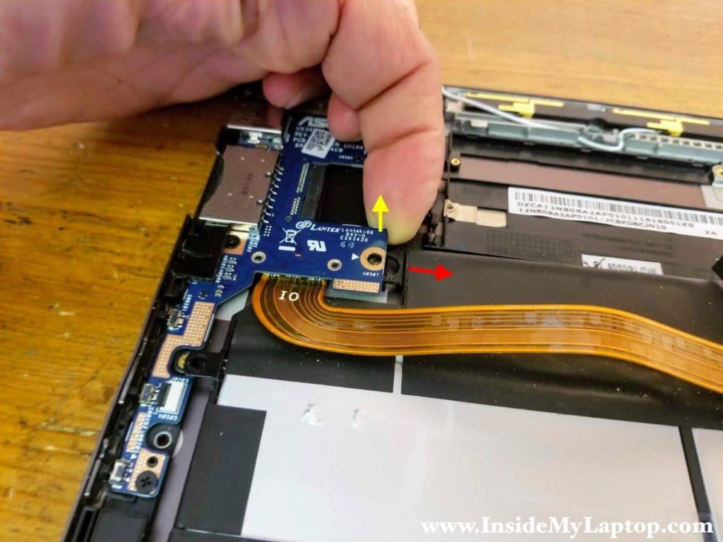 Carefully lift up one side of the USB SD card reader board (yellow arrow) and slide the battery from under the board (red arrow).