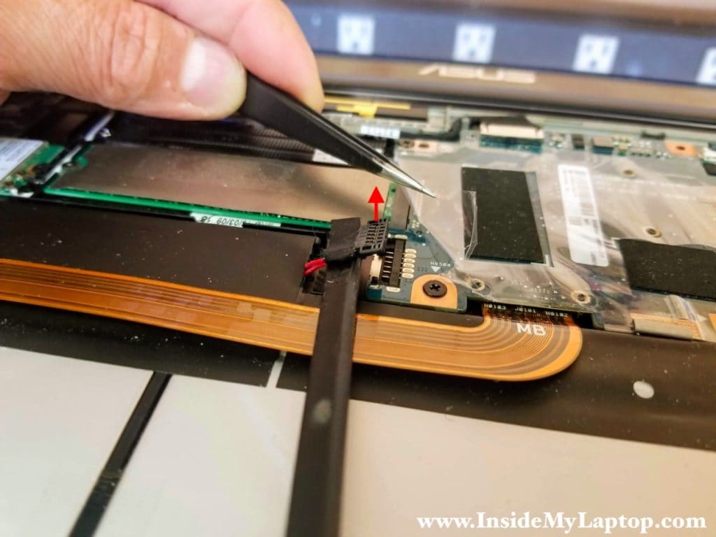 Lift up the battery cable connector to disconnect it from the motherboard.