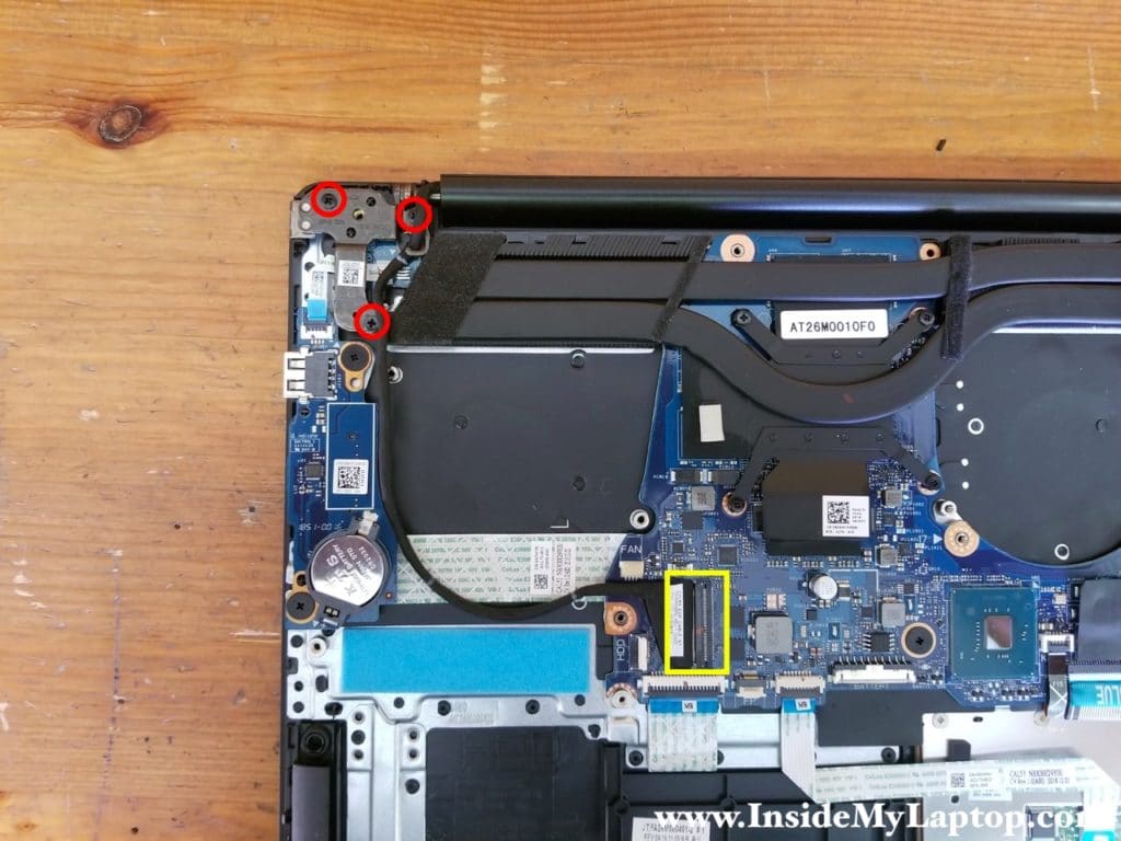 Remove three screws securing the right display hinge and disconnect the display video cable.