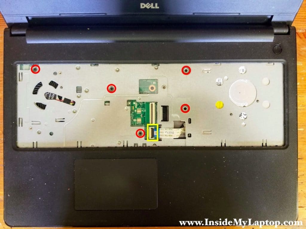 Remove five screws securing the top case and disconnect the optical drive cable from the motherboard.