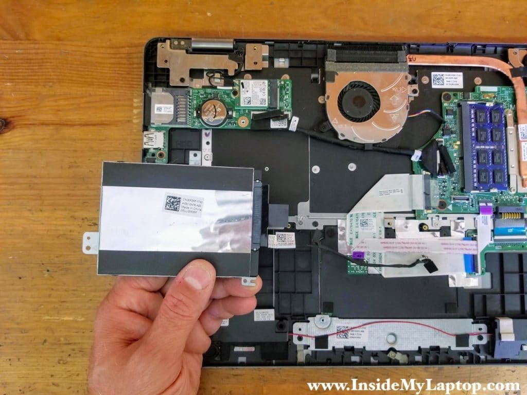 Remove the hard drive assembly with the cable attached to it.