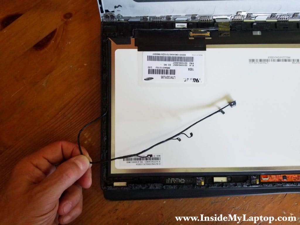 Unroute the cable from the guided path on the left side of the display assembly.