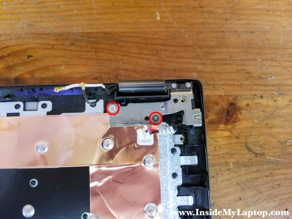 Remove two screws securing the left display hinge.