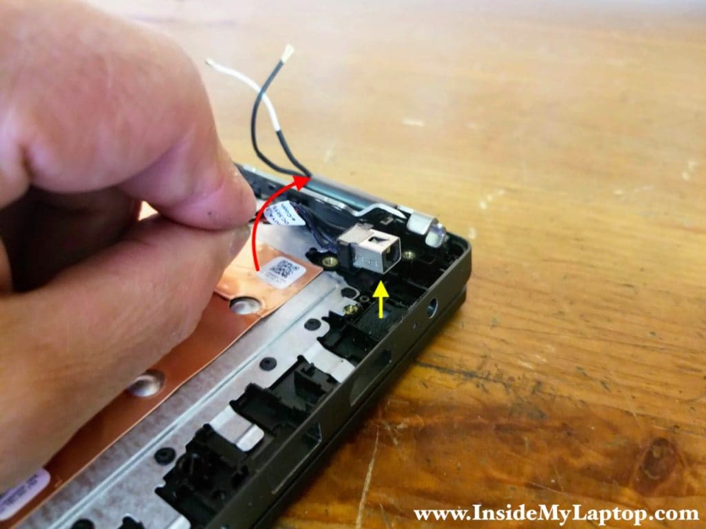 Open up the display hinge and remove the DC power jack.