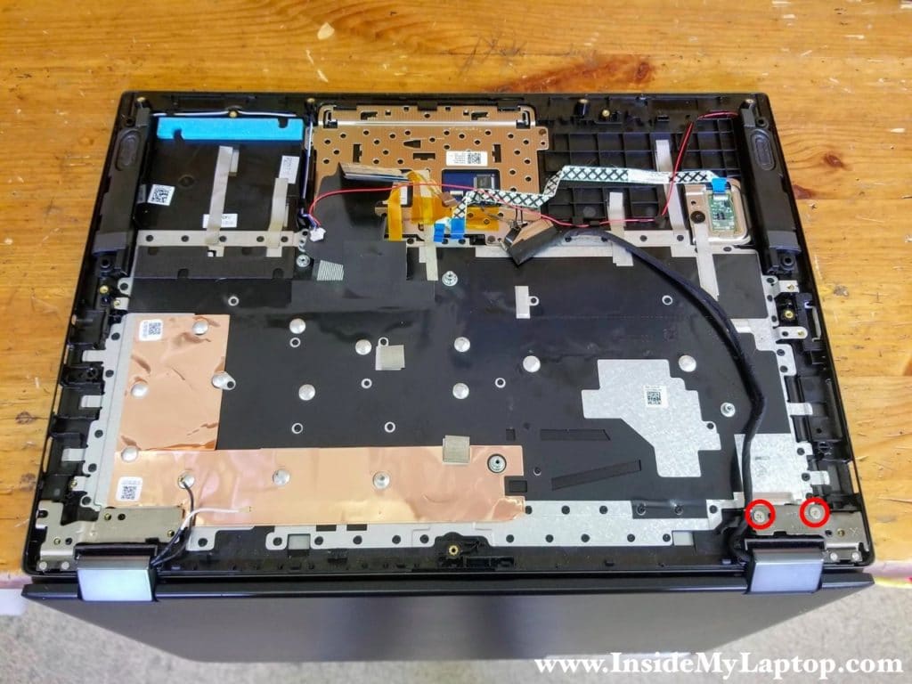 Remove two screws securing the right display hinge.