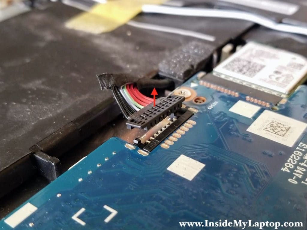 Here's how to disconnect the battery. Lift up the battery connector and unplug it from the motherboard.