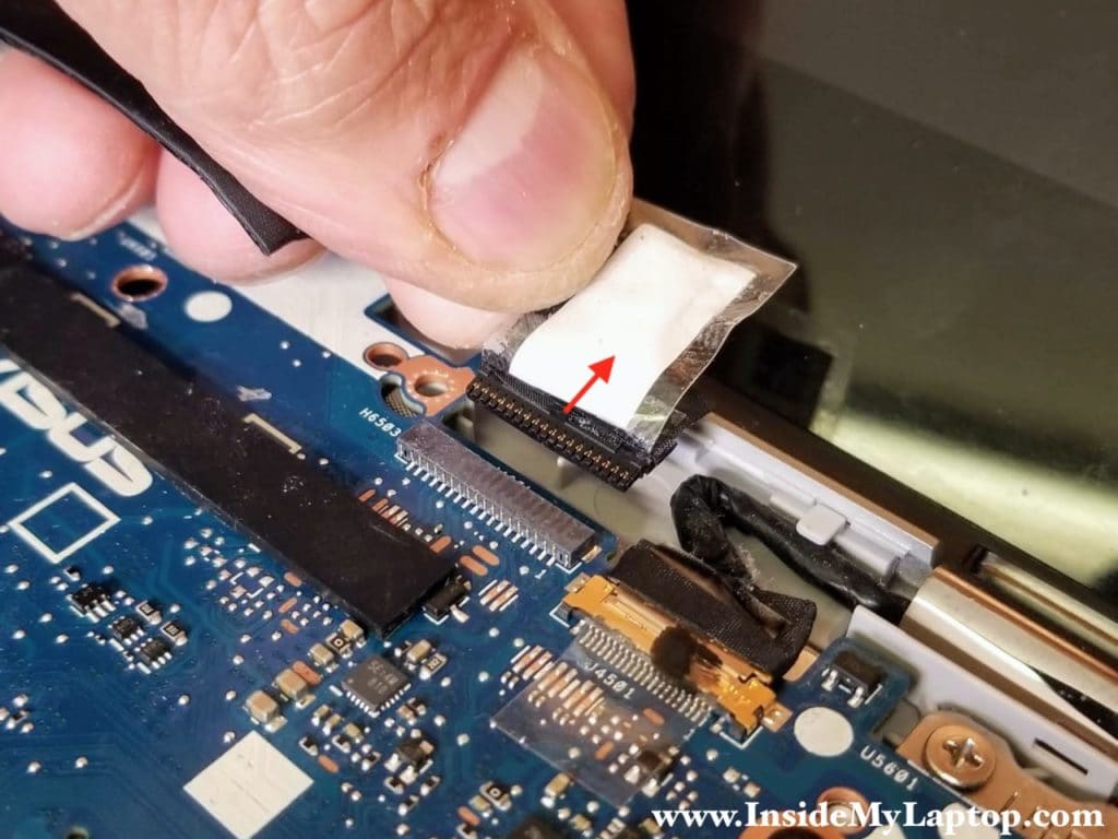 Here's how to disconnect the first display cable with a plastic base.