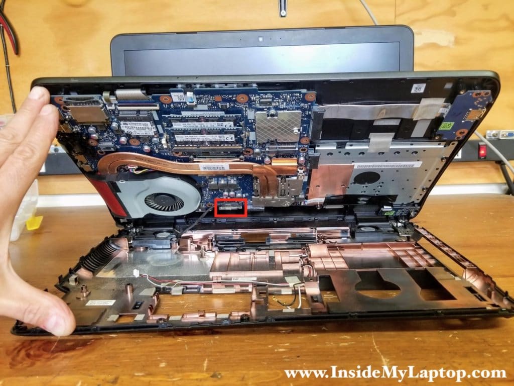 Turn the laptop upside down and lift up the top case until you can access the display cable.