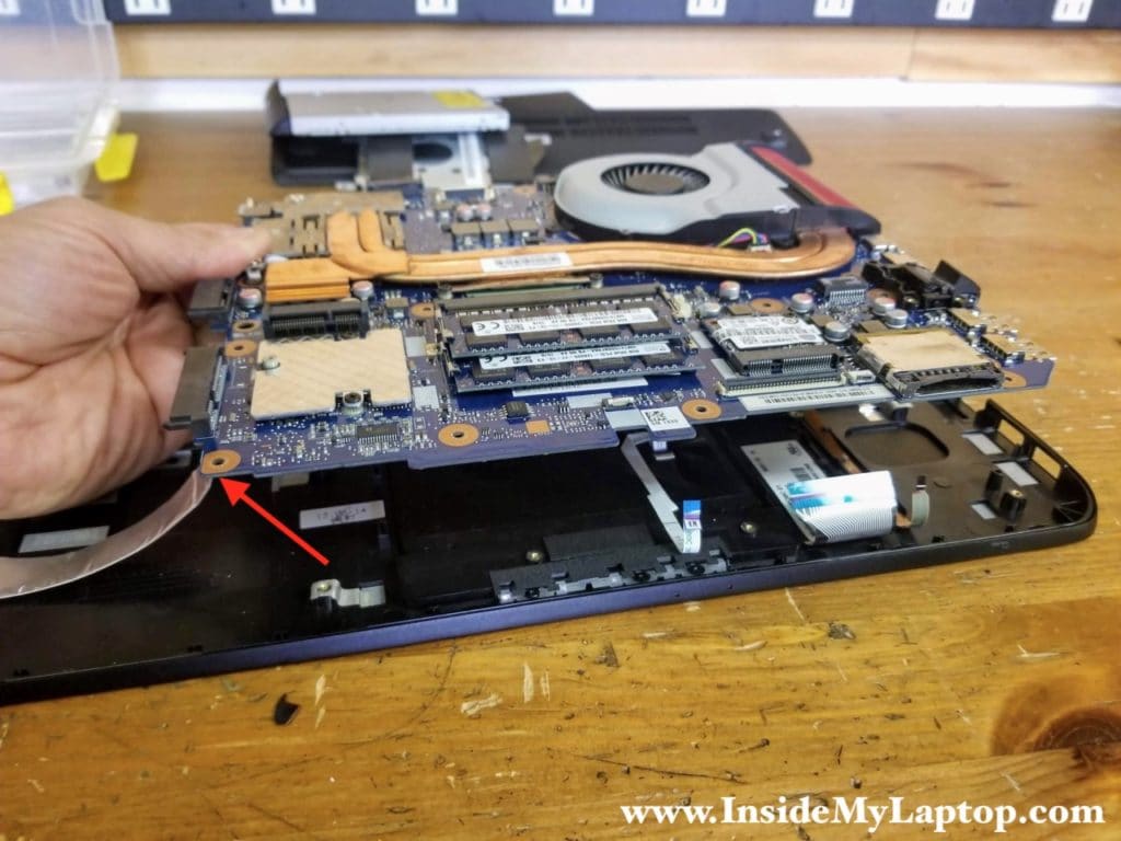 Separate the motherboard from the top case.