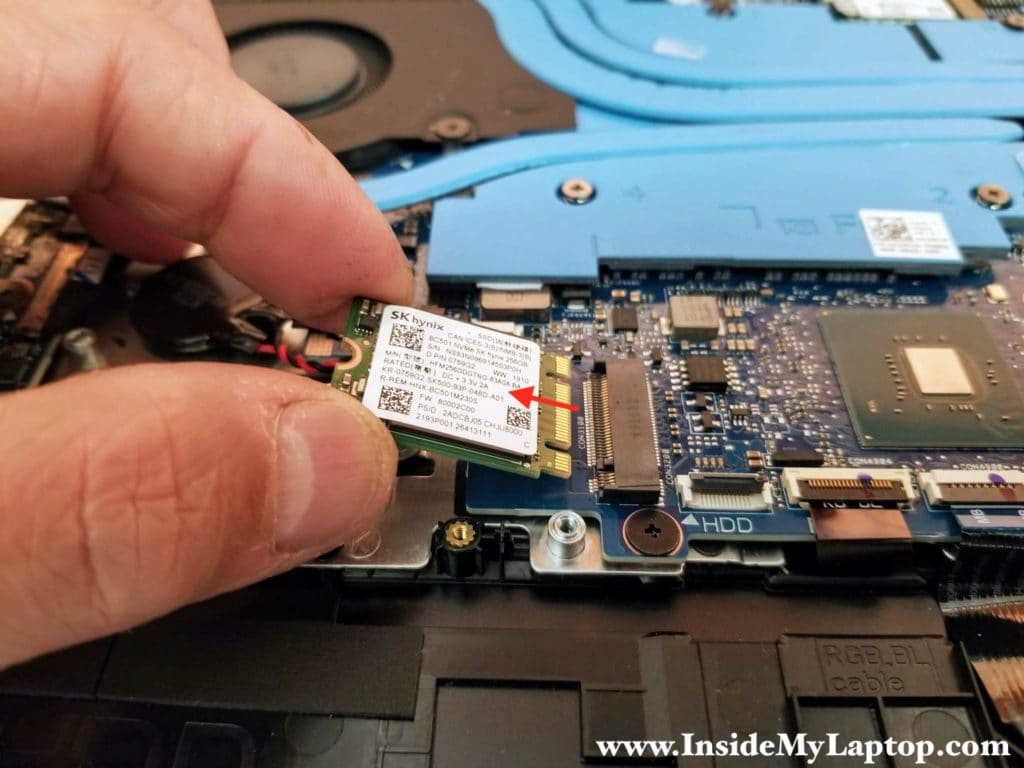 Remove one screw securing the SSD and pull the drive out.