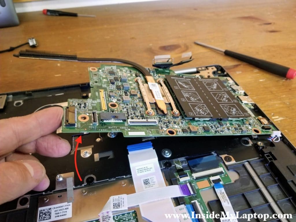 Separate the motherboard from the top case assembly and remove it.