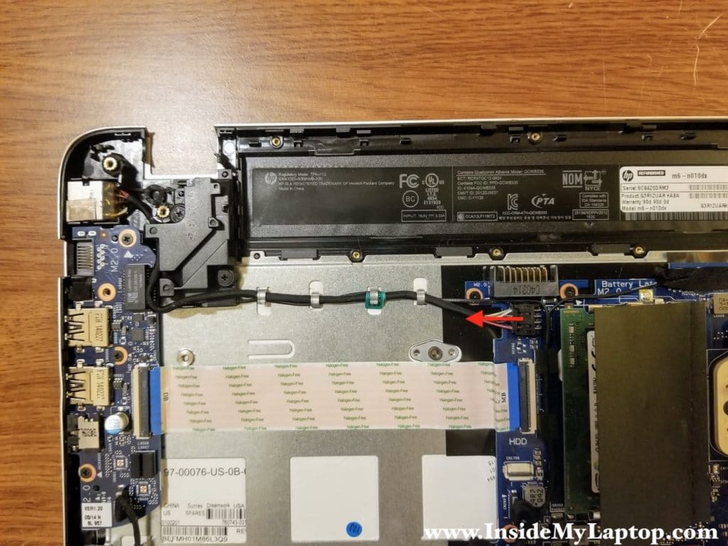 Disconnect the DC jack cable from the motherboard and un-route the cable.