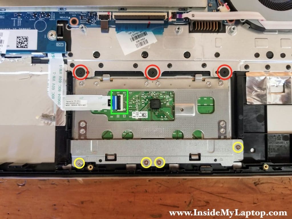 There are seven screws securing the touchpad to the top case assembly.