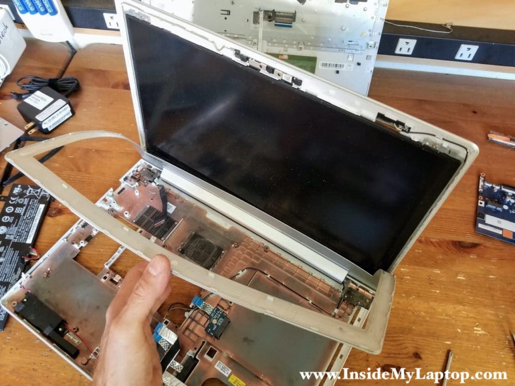 Continue separating the bezel from the display and remove it completely.