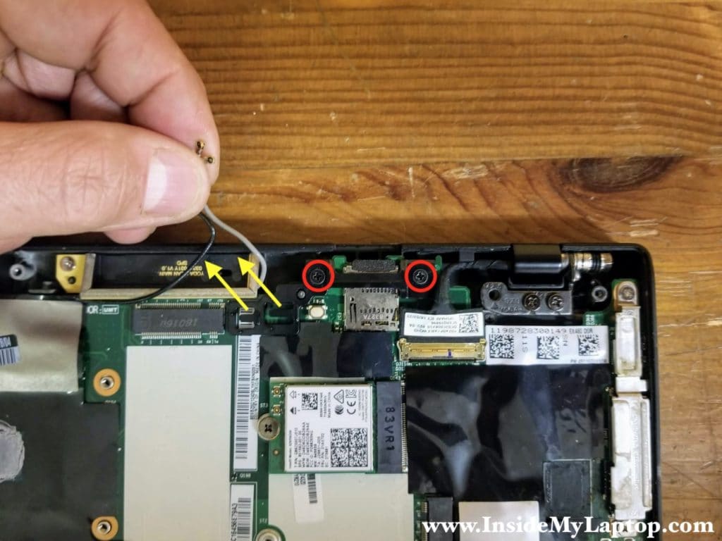 Remove two screws from the Wi-Fi antenna guide.