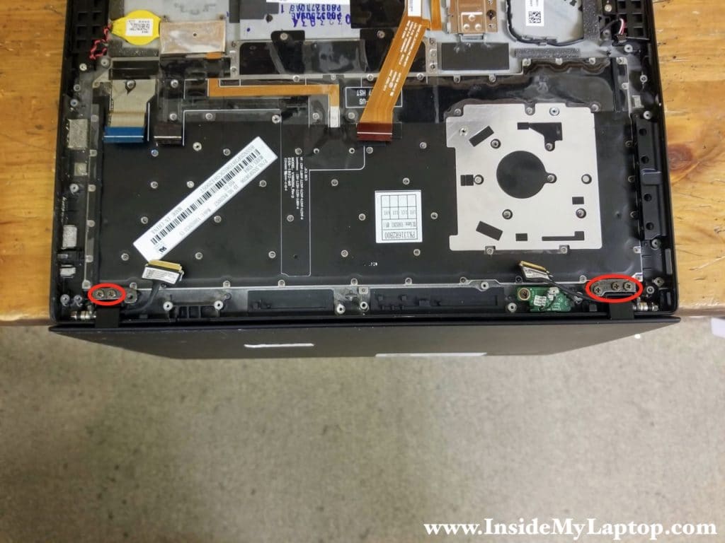 Remove two screws from the left display hinge and three screws from the right display hinge.
