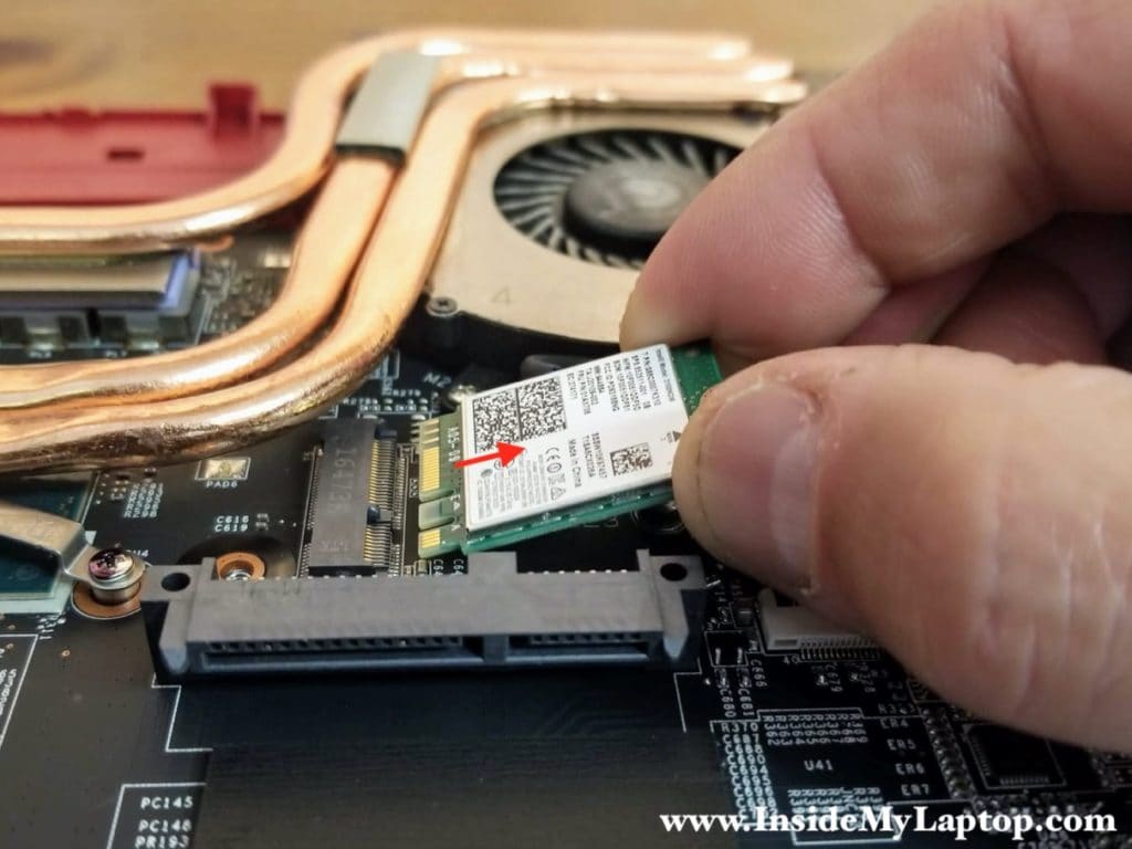 Remove one screw securing the Wi-Fi card and pull the card out.