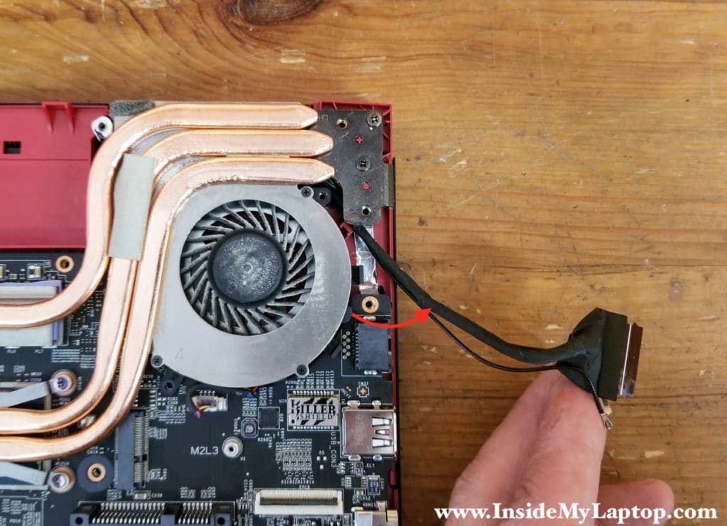 Remove the display cable and Wi-Fi antenna cables from the guided path on the side of the fan.