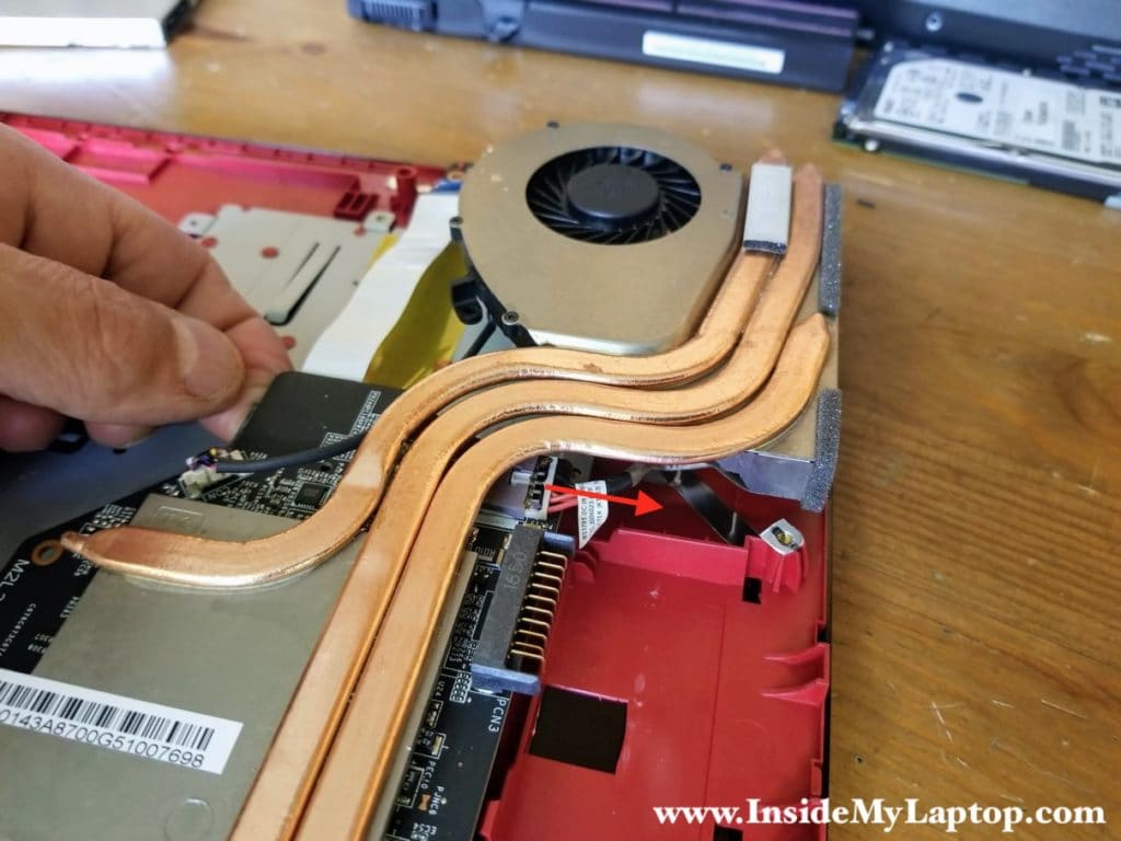 Lift up the motherboard and disconnect the DC power jack cable which is partially hidden under the heatsink.