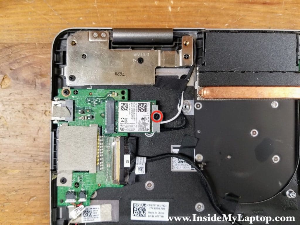 Remove one screw from the Wi-Fi card mounting bracket. Remove the bracket.