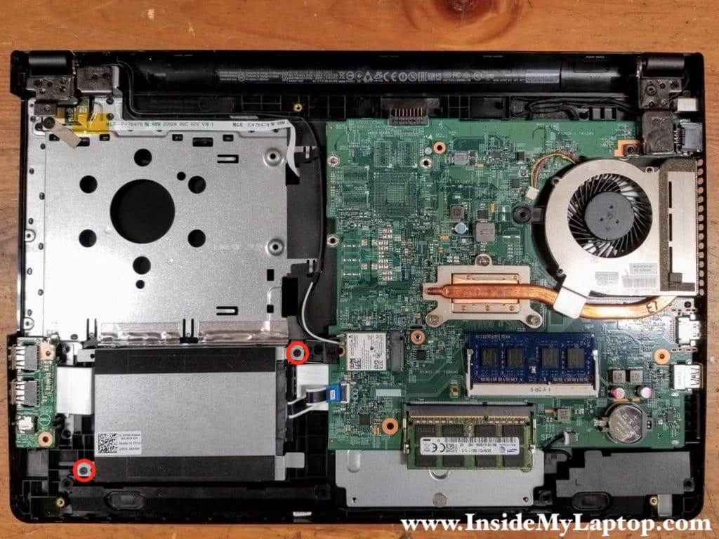 Remove two screws attaching the hard drive caddy to the top case.