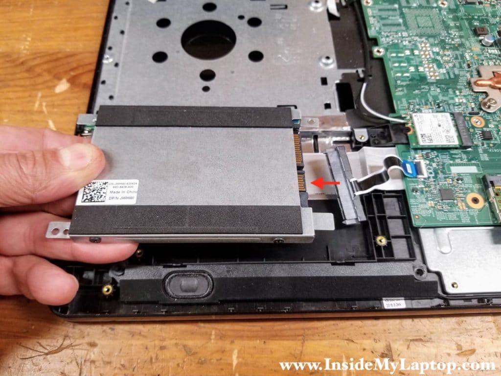 Carefully lift up the hard drive assembly and disconnect it from the SATA cable.