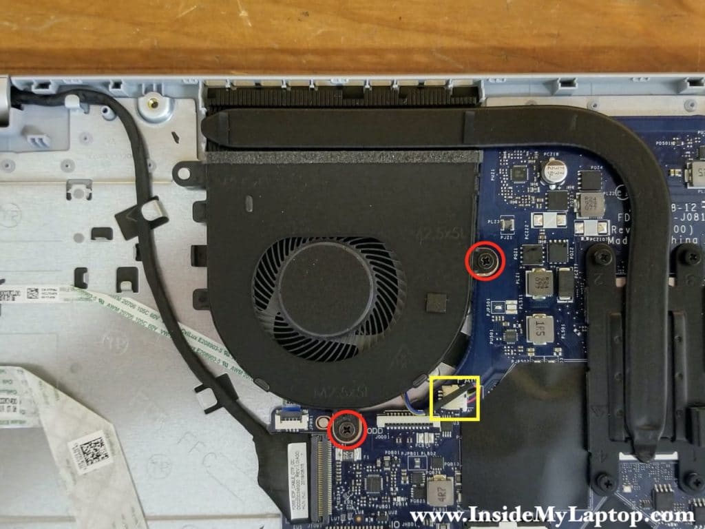 Remove two screws securing the cooling fan and disconnect the fan cable from the motherboard.