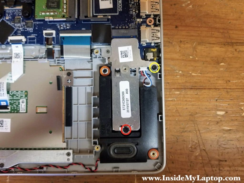 Remove one regular screws (red) and loosen one captive screw (yellow) securing the PCIe M.2 SSD support bracket/heatsink.