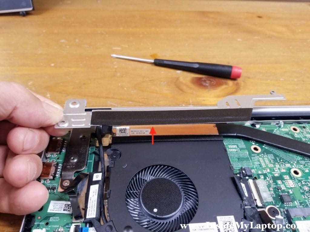 The bracket attached to the fan with adhesive. Carefully peel off the bracket and remove it.