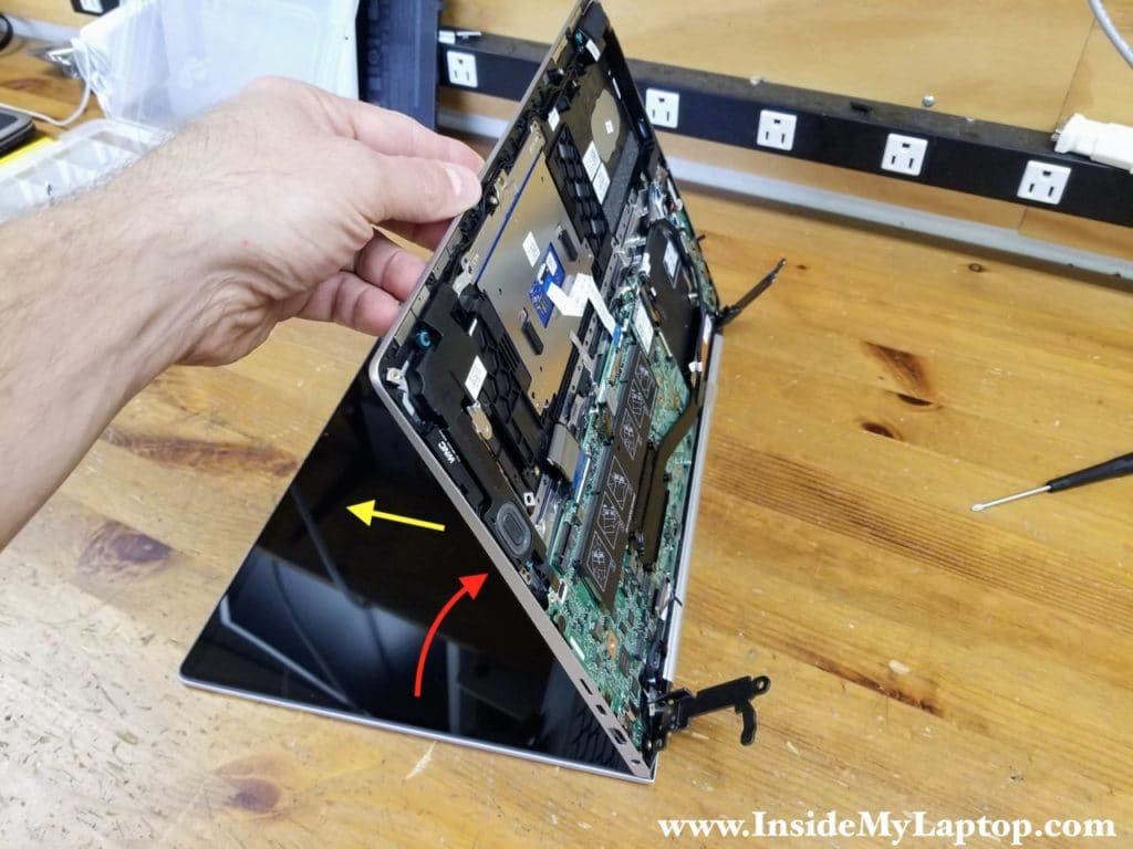 With both hinges lifted up and all cables disconnected, you can start removing the display panel.